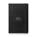 The Human Premium black hardcover lined notebook, front cover with wordmark